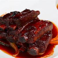 Grilled Baby Short Ribs · Korean style grilled marinated baby short ribs, served with steamed onions.
