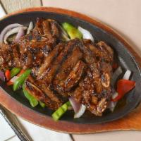 Baby Short Ribs · Korean style grilled marinated baby short ribs, served with steamed onion.