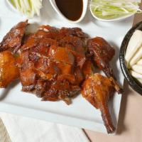 Moca Roasted Peking Duck · Peking style roasted duck served with steamed mini buns and hoisin sauce.