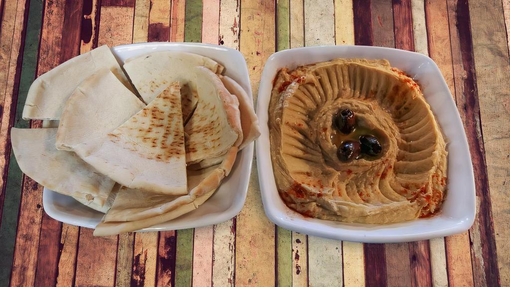 Grilled Eggplant · Signature zamaan eggplant topped with olives and served with pita bread.