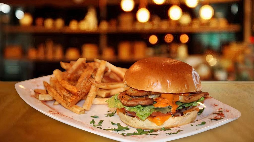 Bohemian Burger · Crispy chicken breast, lettuce, tomato, grilled onions, mozzarella cheese, honey mustard. Served with french fries.