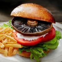 Holly Burger · Mushrooms, grilled onions, tomato and lettuce topped with Swiss cheese. Served with french f...