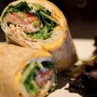 Buffalo Chicken Wrap · Sliced chicken breast tossed in buffalo sauce with melted cheddar cheese, romaine lettuce, s...