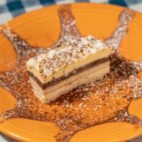 Torta Nocciola · Alternating layers of hazelnut cake, hazelnut cream and chocolate cream, topped with praline...