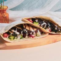 Eggplant Pita Sandwich · Grilled eggplant with shredded cabbage, diced tomato and cucumber, and a tahini drizzle wrap...