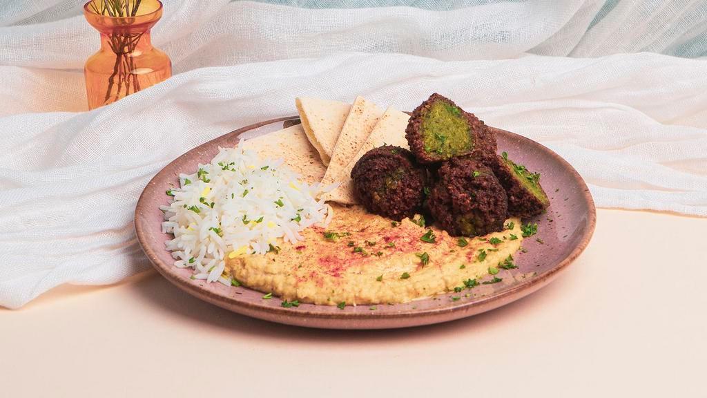 Hummus Falafel Plate · Hummus with falafel and chopped parsley, drizzled with olive oil and topped with a sprinkle of paprika.