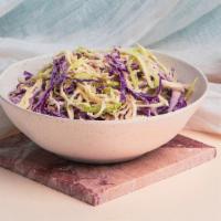 Cabbage Slaw · Sliced cabbage in tahini dressing.