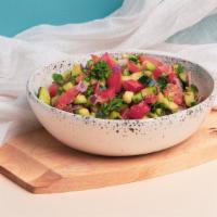Israeli Salad · Fresh diced tomato, cucumber, and parsley with olive oil.