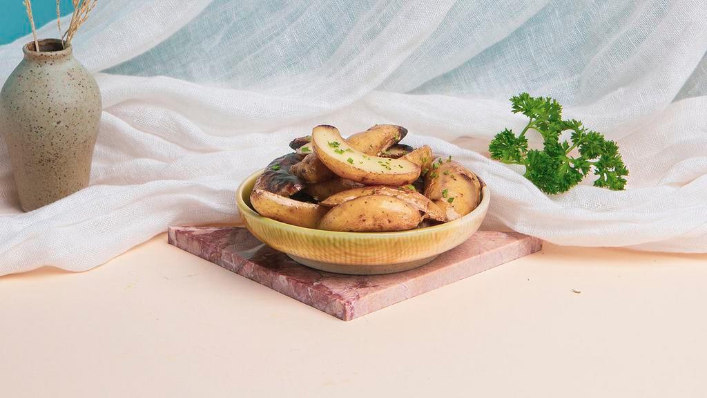 Roasted Potatoes · Roasted potatoes tossed with chopped parsley and olive oil.