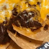 Nachos- Texas Chili · Freshly fried chips topped with Texas Chili, cheddar, monterey jack cheese, sour cream & jal...
