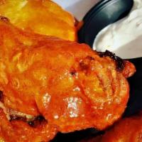 Buffalo Wings · Jumbo chicken wings, dry rubbed, baked then fried to delicious crispiness served with homema...