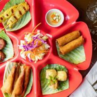 Red Basil Combo · Combination of spring roll, Thai sui mai, fried shrimp roll, Thai fish cake, and grilled chi...