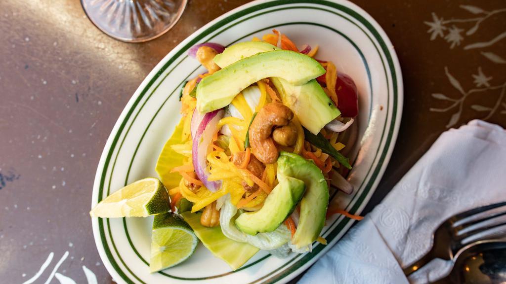 Mango Salad · Spicy. Green mango with avocado, mint, red onion, cashew nut carrot in a lime dressing.
