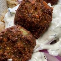 Falafel Plate · Served with Brown Rice, Grilled Peppers & Onions, Pita & Tzatziki. Served with 2 sides.