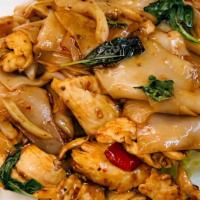 Drunken Noodles · Hot and spicy. Sautéed fresh flat noodles with egg, tomato, onion, bok choy, Thai basil in f...