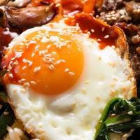 Bibimbap · Rice topped with assorted vegetables, sesame oil, gochujang, and a fried egg. Add in some Bu...