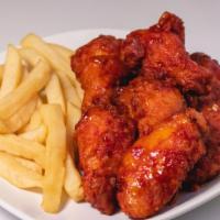 Spicy Pepper Chicken Wings · Fried wings tossed in a Spicy Pepper glaze. Served with fries.