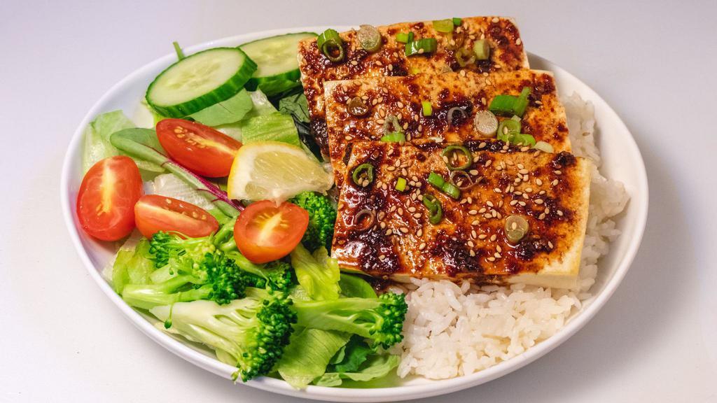 Tofu Bowl (V) · Pan seared tofu sautéed in Teriyaki, Soy, or Spicy Gochujang sauce. Served over rice, diced cabbage & pickled onions.