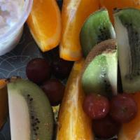 Fresh Fruit Salad · Melon, grapefruit, oranges, pineapple, grapes, and bananas.
