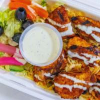 Shish Tawook Over Rice · BBQ chicken cubes with medi-spices served with rice or over a bed of lettuce with special ga...