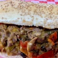Philly Cheese Steak Sub · Sliced thin tender beef with Onions, Red and Green Peppers and Cheddar Cheese Sauce piled up...