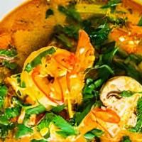 Tom Yum · Tomato, mushroom, onion and cilantro simmered in tangy lemongrass-kaffir-thai ginger broth s...