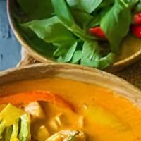 Panang Curry · Panang red curry paste in coconut milk with pea basil and ground peanuts.