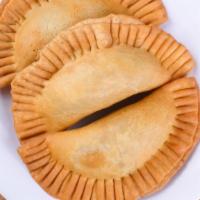 Empanadas · Fried pastry shell filled with beef or chicken.