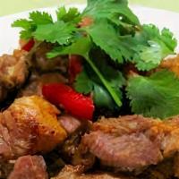 Pork Griot · Medium rice and peas with  pork griot