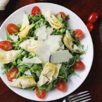 Personal Arugula Salad · Cherry tomatoes, grana padana, artichoke hearts, lemon vinaigrette.