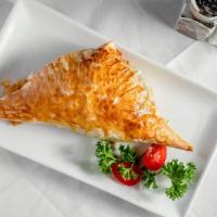 Spanakopita · Spinach and feta cheese baked in phyllo.