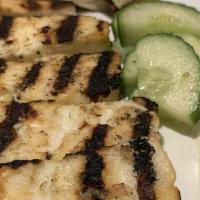 Grilled Haloumi · Served with pita and sliced cucumber garnish.