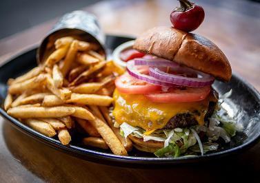 Crave Burger · Certified Angus Beef sprinkled with house seasoning and char broiled, topped with naturally smoked cheddar, iceberg lettuce, beefsteak tomatoes, and Crave signature house-made burger sauce.