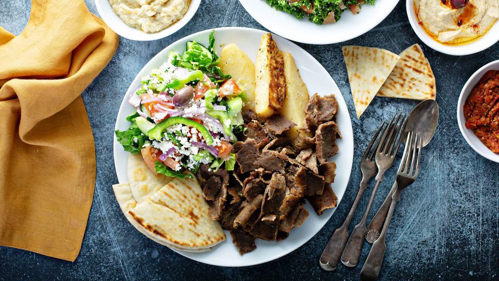 Chicken And Lamb Gyro Platter · Flavorful lamb and juicy chicken gyro served with your choice of sauce, rice and a side salad.