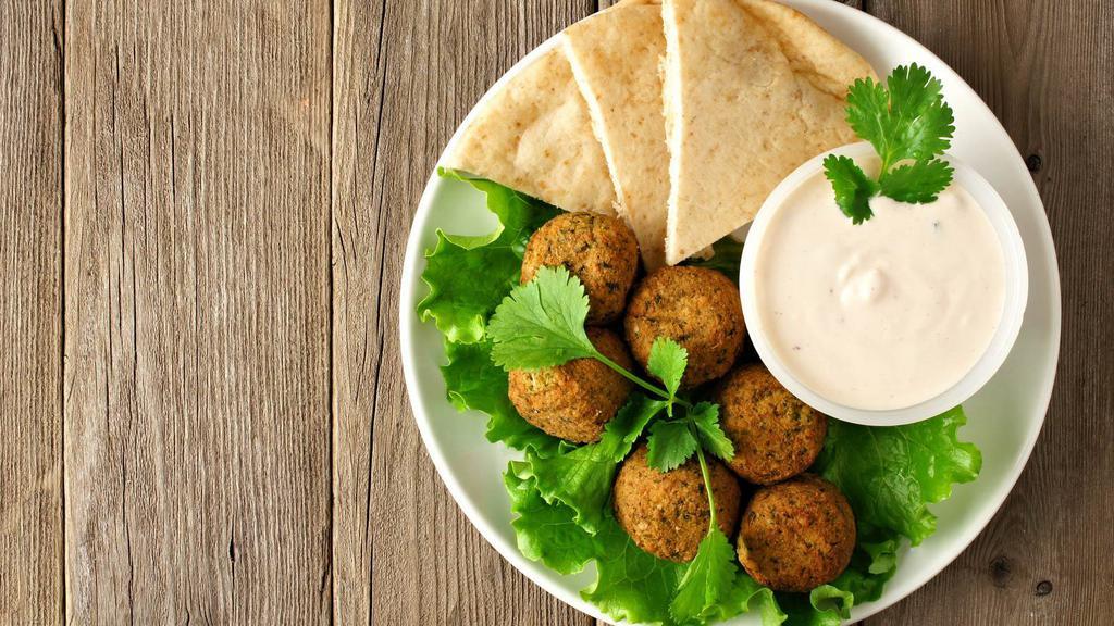 Falafel Platter · Tasty garbanzo bean patties fried to golden brown. Served with your choice of sauce, rice and a side salad.