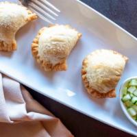 Golden Curry Puff · Filled with ground chicken curry, herb and cucumber relish.