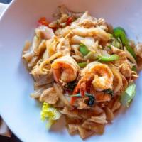 Pad Kee Maow · Sautéed flat rice noodle with chicken, shrimp, squid, fresh chili, shallot, onion, and Thai ...