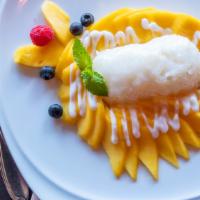Sweet Sticky Rice Topped With Fresh Mango · Served with coconut milk sauce.
