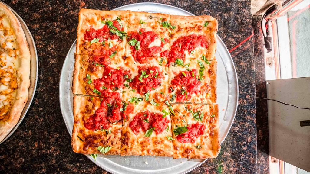 Grandma Pie · Extra thin crust pan pizza layered with mozzarella cheese and spotted with garlic and san marzano crushed plum tomato sauce.