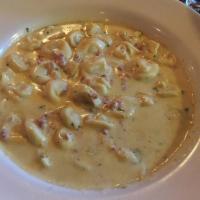 Tortellini Carbonara · Cheese filled pasta in a light and delicate cream sauce with minced prosciutto. Served with ...
