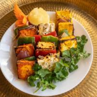 Tandoori Malai Paneer Tikka · Paneer cubes, peppers, and onions marinated in in-house white creamy marination. Cooked in t...