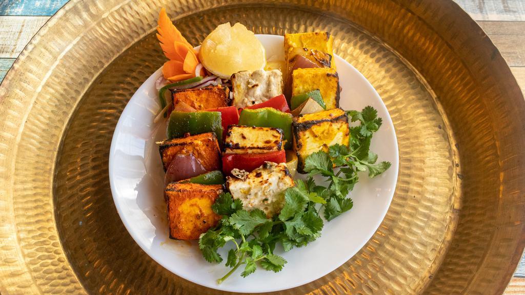 Tandoori Malai Paneer Tikka · Paneer cubes, peppers, and onions marinated in in-house white creamy marination. Cooked in tandoor.