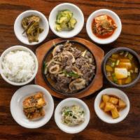 Bulgogi · Thin slices of marinated beef sirloin with assorted mushrooms and vegetables grilled togethe...