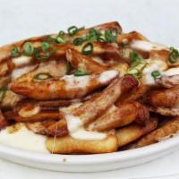 Chelsea Bell Poutine · Hand cut fries with melted cheese curds, homemade gravy topped with scallions.