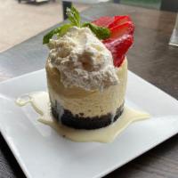Oreo Cheesecake · Vanilla bean cheesecake, oreo cookie crust, white chocolate sauce, fresh strawberry garnish,...