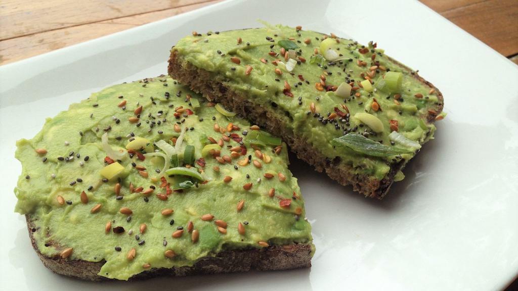 Avocado Toast · Mashed avocado with flax seeds, chia seeds, scallions, red pepper flakes with hint of lemon on multigrain toast.