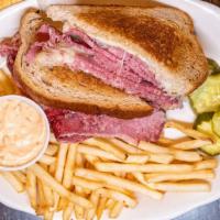 Reuben · Sliced corned beef with sauerkraut & melted Swiss on grilled rye with thousand island dressi...