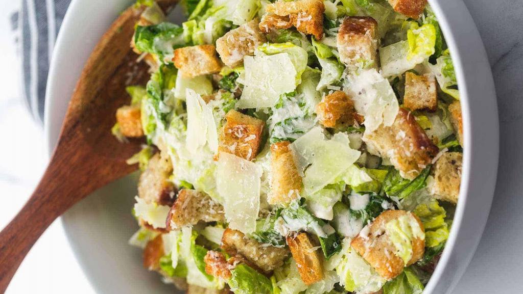 Caesar Salad · Romaine lettuce, onions, croutons and grated cheese, served with a side of Caesar dressing.