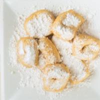 Zeppoles · Fresh fried dough covered with powdered sugar