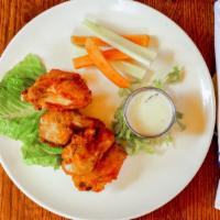 Buffalo Wings · Tossed in choice of: BBQ or buffalo sauce served with blue cheese dip.